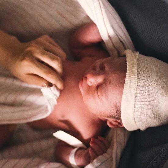 Newborn baby being checked after birth