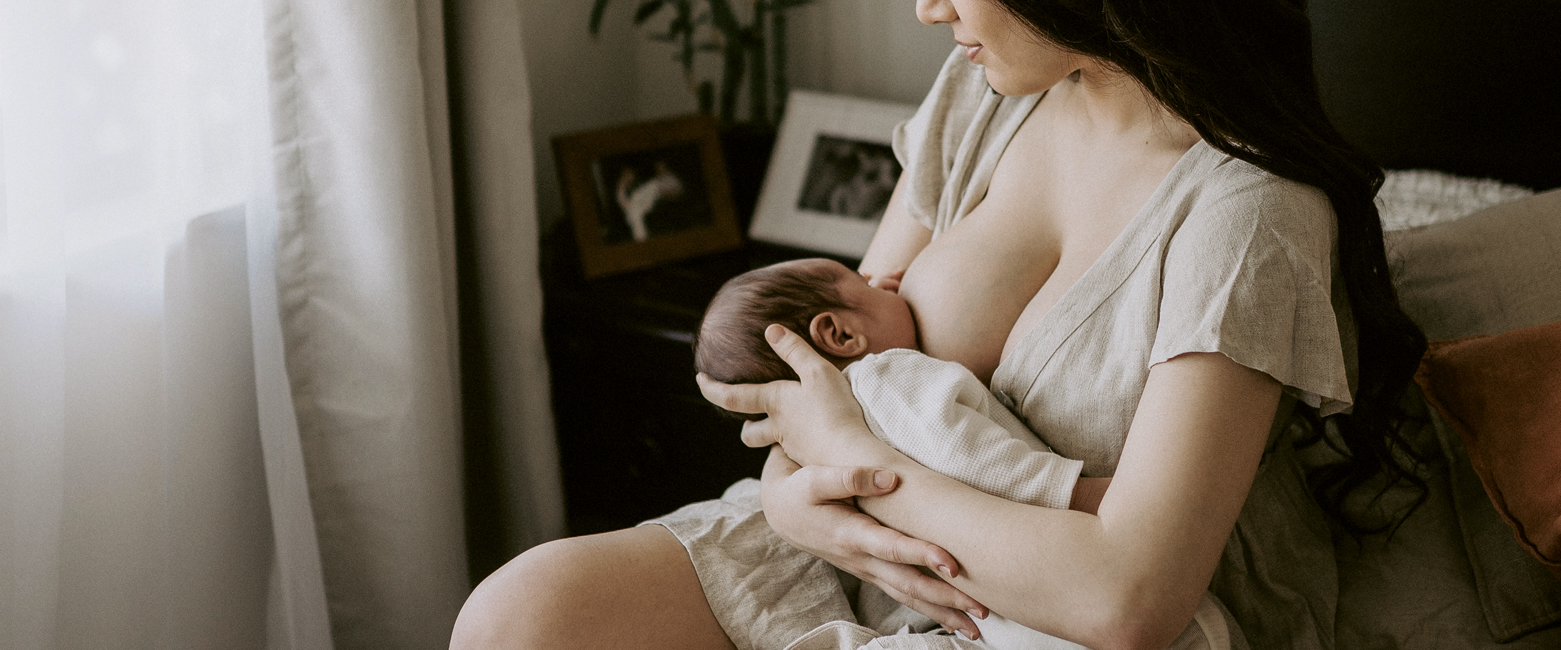 Mum breastfeeds newborn baby