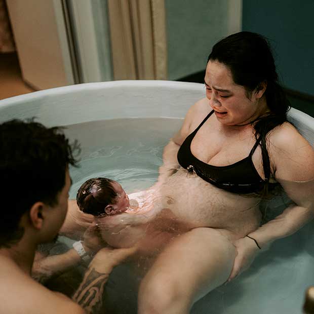Kiwi mum pushing and birthing baby in water
