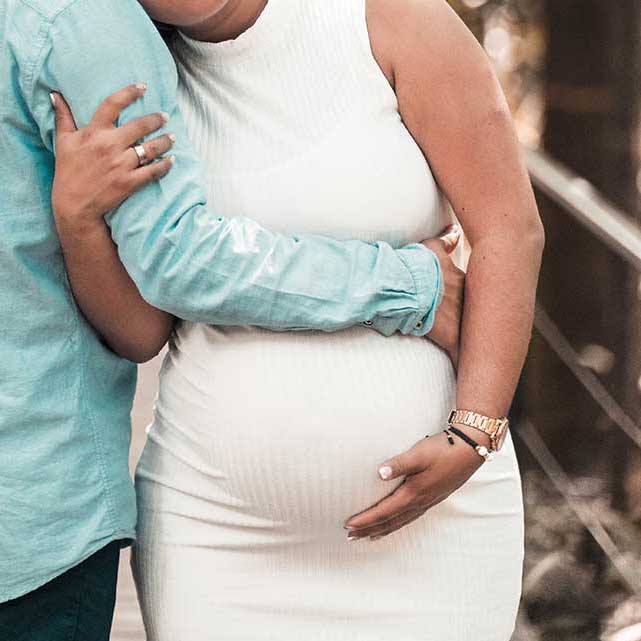 Man embraces pregnant wife