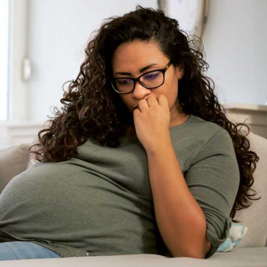 Pregnant woman looking uncertain