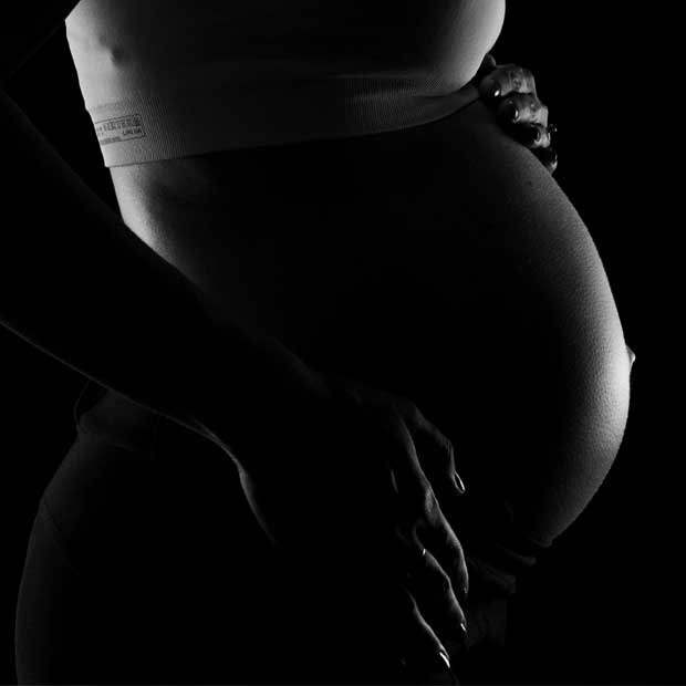 Pregnant woman's belly in black and white photo