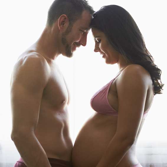 Pregnant couple getting intimate