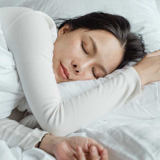 Woman going to sleep in bed