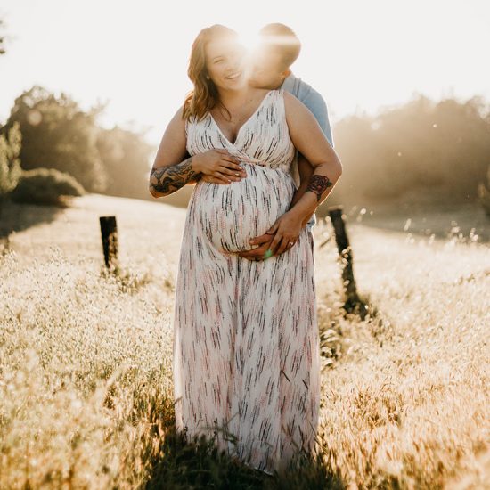 Couple hugging in maternity shoot