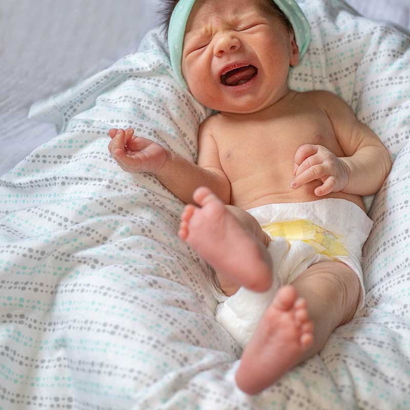 A baby with constipation may cry and look uncomfortable