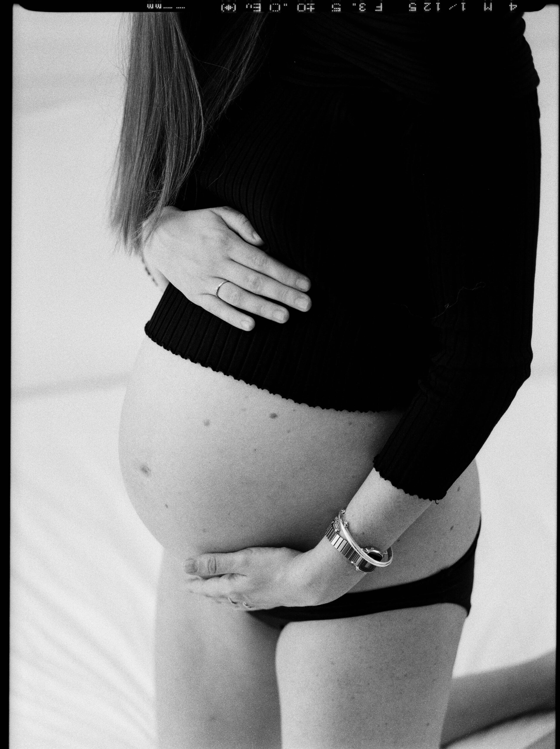 Pregnant mama holds her belly during home birth