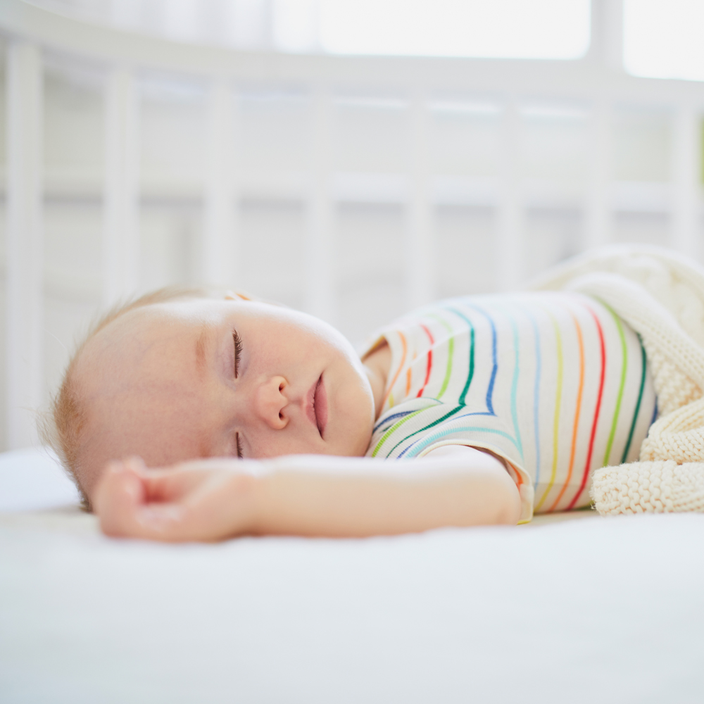 Baby sleeps in cot