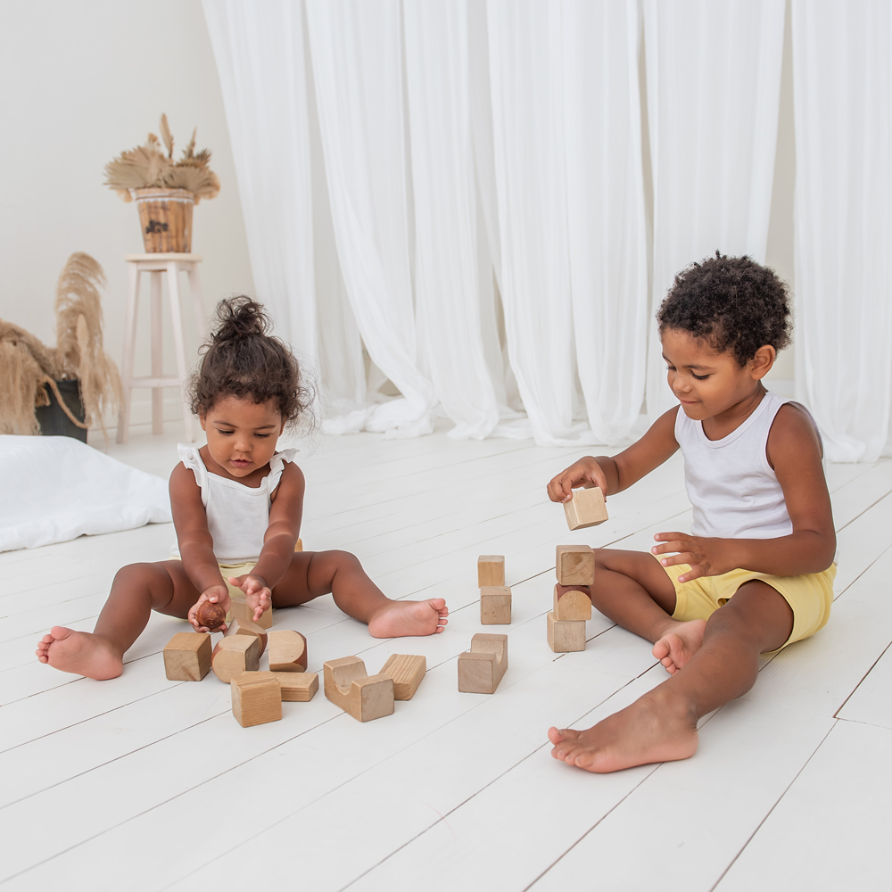 Children sitting on the floor playing with blocks