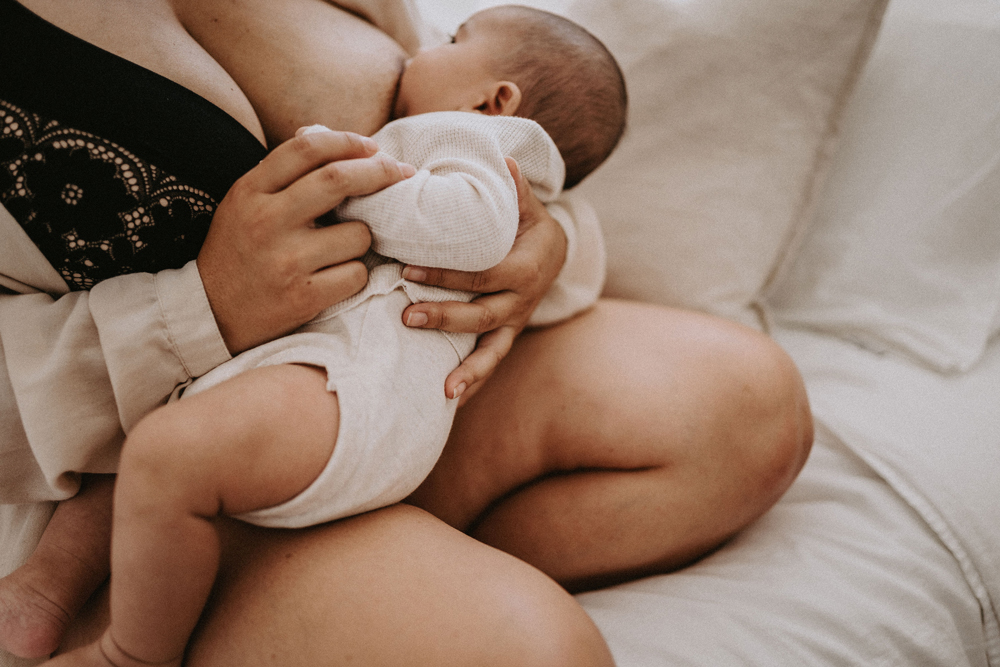 Newborn baby breastfeeding in postpartum period